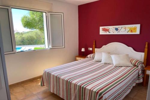 a bedroom with a bed and a window at Marina in Cala en Blanes