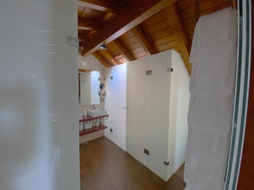 a bathroom with white cabinets and a sink at Na Crista da Onda in Nazaré