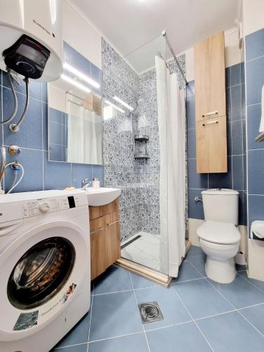 a bathroom with a washing machine and a toilet at Becici Studio Apartment in Budva