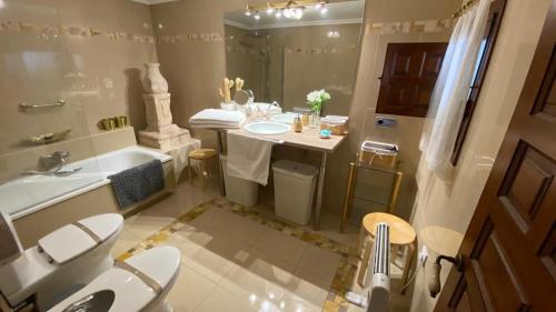een badkamer met een wastafel, een toilet en een bad bij La Posada de Chinchilla in Chinchilla de Monte-Aragón