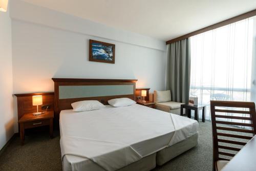 a hotel room with a bed and a window at Lion Sunny Beach Hotel in Sunny Beach