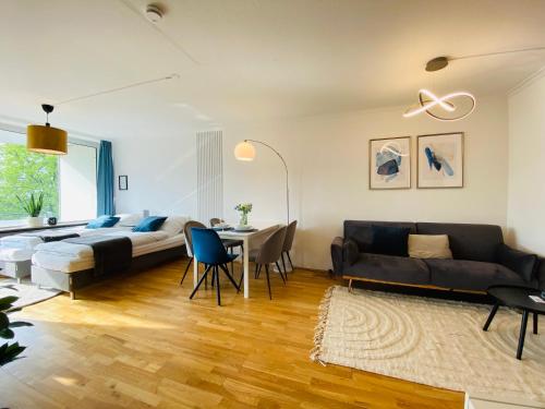 a living room with a bed and a dining room at KYANIT APARTMENT: FREE PARKING + POOL + NETFLIX in Wuppertal
