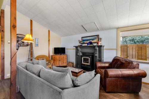 a living room with two couches and a fireplace at Beach Haven in Lincoln City