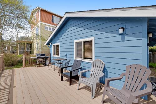 a blue house with chairs and a table on a deck at Beach Haven in Lincoln City