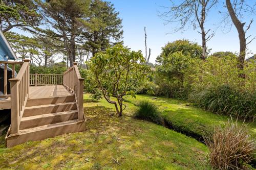 a wooden staircase leading to a yard with grass and trees at Beach Haven in Lincoln City