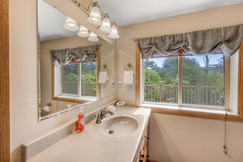 a bathroom with a sink and a mirror at Beach Haven in Lincoln City