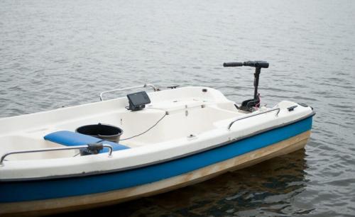 a white and blue boat sitting in the water at Apartmány u Dlouhána in Kadaň