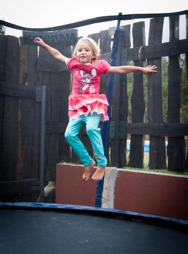 a little girl jumping on a trampoline at Apartmány u Dlouhána in Kadaň