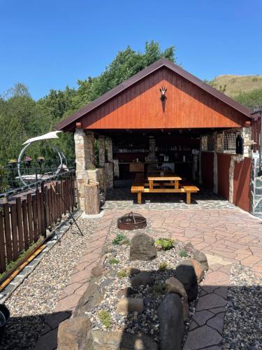 a pavilion with a picnic table in front of it at Apartmány u Dlouhána in Kadaň