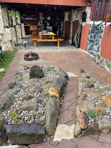 a garden with rocks and a table and a bench at Apartmány u Dlouhána in Kadaň