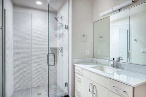 a bathroom with a sink and a glass shower at NoMa 1br w wd concierge gym nr Metro WDC-645 in Washington, D.C.