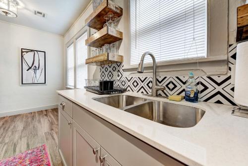 a kitchen with a stainless steel sink and a window at Lincoln Lodge A near OU Med Bricktown Arena in Oklahoma City