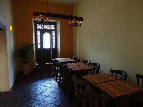 a dining room with tables and chairs and a window at la posada del angel in Zipaquirá