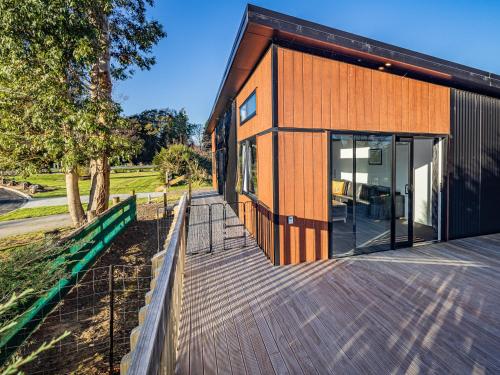 a wooden walkway leading to the front of a house at Modern Mountain Escape - Ohakune Holiday Home in Ohakune