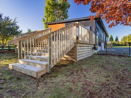 a wooden staircase leading up to a house at Modern Mountain Escape - Ohakune Holiday Home in Ohakune