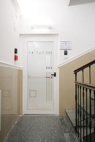 a white door with a sign on it at Hotel Terrazza Magenta in Rome