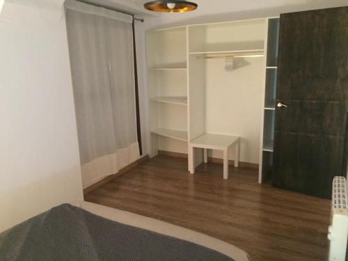 a room with a bed and a closet and a desk at Casa Latre Somontano in Barbastro