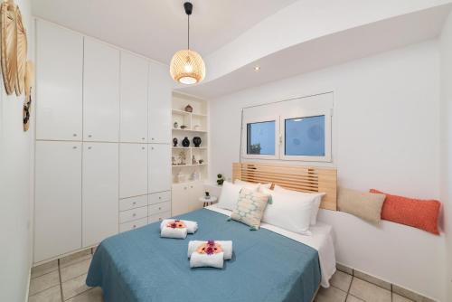 a bedroom with a large bed with two pillows at Beachfront luxury Villa in Ammoudara, Crete in Amoudara Lasithiou