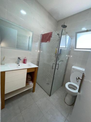 une salle de bain avec une douche, des toilettes et un lavabo dans l'établissement דירת נופש בבית שאן, à Beït Shéan