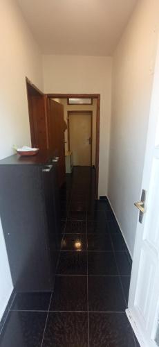 a hallway of a room with a tile floor at Hostel Olea in Podgorica