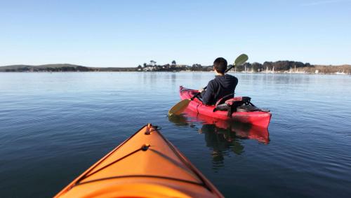 a man sitting in a kayak on a lake at Indianhead Ironwood Hotel in Ironwood
