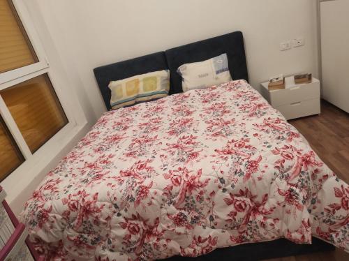 a bedroom with a bed with a red and white blanket at Modern apartment in Tirana in Tirana