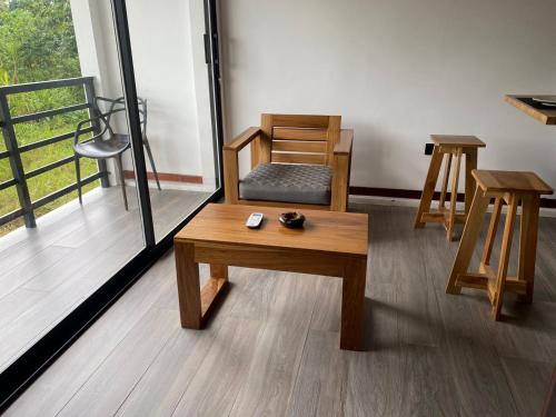 a room with two tables and a chair and a table and stool at Bunker593 Inn in Tena