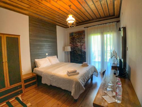 a bedroom with a bed and a table in it at Hotel Apsis in Emporio