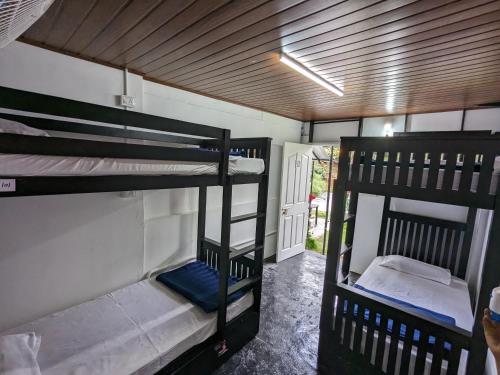 a room with two bunk beds and a hallway at Multiple Stories, Wayanad in Wayanad