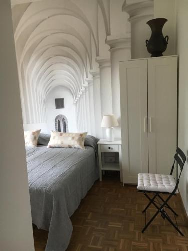 a bedroom with a bed and a chair at Villamonestevole501 in Umbertide