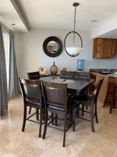 a dining room table and chairs in a kitchen at The Dolphins Ocean Front-Beach 2 BR 2Bth in Rosarito