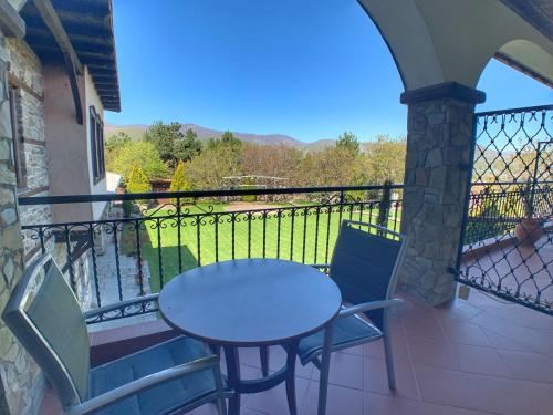 a table and chairs on a balcony with a view at Hotel Apsis in Emporio