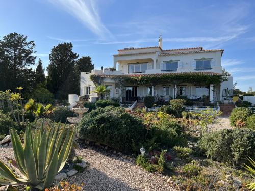 a house with a garden in front of it at 233 Casa Galo Verde Apartments in Porches