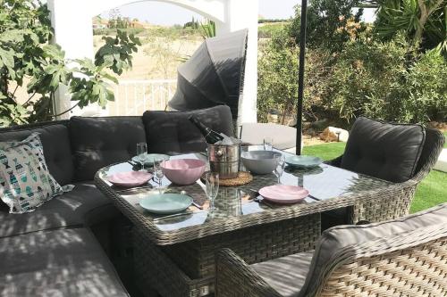 a table with bowls and plates on a couch at Casa Alegria Spain Entire Home Private Pool in Antas