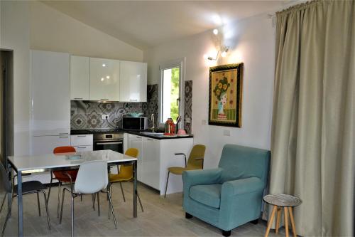 a kitchen and dining room with a table and chairs at - La Casa delle Meraviglie- Anima Sarda in Porto Pino