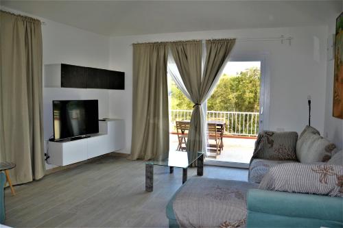 a living room with a couch and a television at - La Casa delle Meraviglie- Anima Sarda in Porto Pino