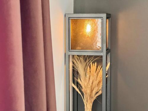 a mirror with a plant in it next to a curtain at Sargsyan ECO house in Sevan