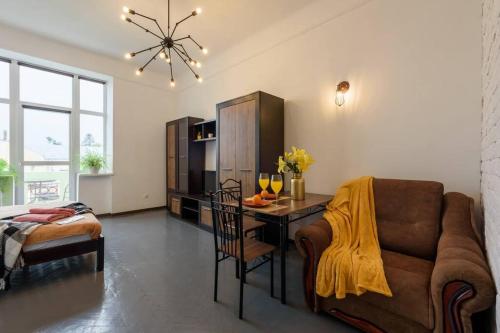a living room with a couch and a table at Апартаменти в історичному центрі міста Чернівці in Chernivtsi