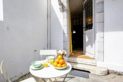 une table blanche avec des bols de fruits sur elle dans l'établissement Appartement Yema - Welkeys, à Biarritz