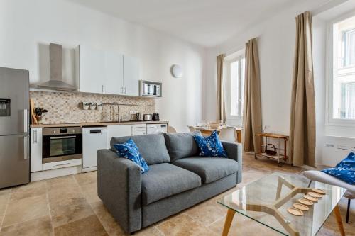 un salon avec un canapé et une cuisine dans l'établissement Appartement Immaculia - Welkeys, à Cannes