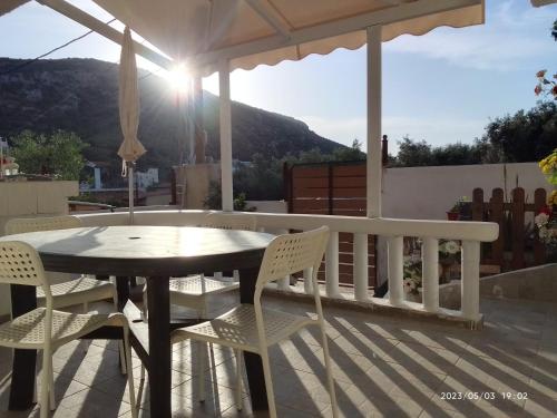 een tafel en stoelen op een patio met uitzicht bij Antonia family house near Airport in Porto Rafti