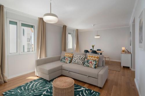 a living room with a couch and a table at Solar da Fontinha by An Island Apart in Santa Cruz