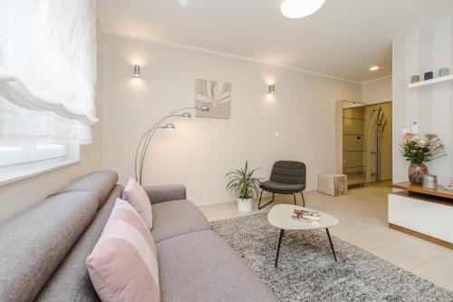 a living room with a couch and a table at Villa Karla in Zadar