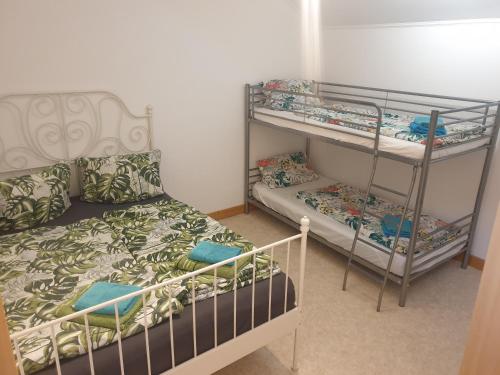 a bedroom with two bunk beds and a bed at Santos in Kappel-Grafenhausen