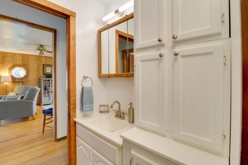 a bathroom with a sink and a mirror at Charming Parsons Cabin with Grill on the Cheat River in Parsons