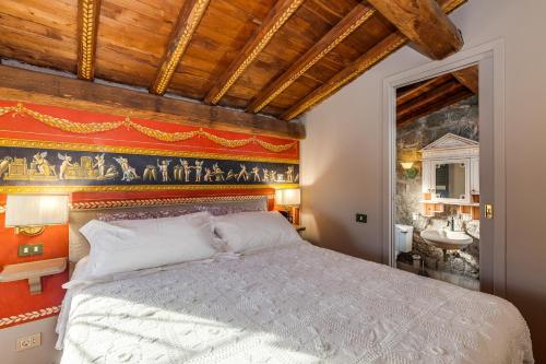 a bedroom with a king sized bed and a painting on the wall at Roman Oasis Villa in Ciampino
