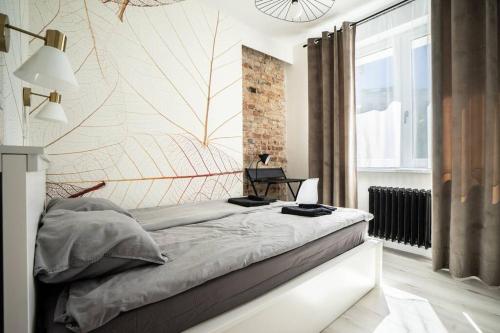 a bedroom with a large bed with a wall at Apartment Marszalkowska Premium Warsaw City Center in Warsaw