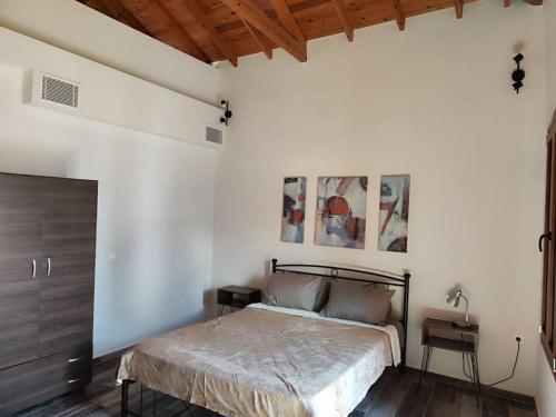 a bedroom with a bed and a wooden ceiling at Two-storey house in Kardamyla in Mármaron