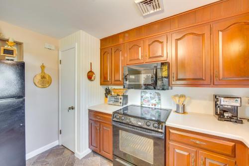 a kitchen with wooden cabinets and a stove at 10 Mi to Dtwn Lancaster Charming Home with Yard! in Leola