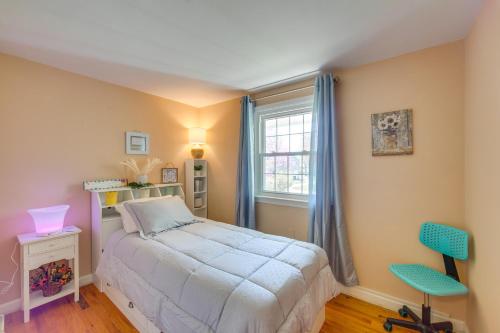 a bedroom with a bed and a window and two chairs at 10 Mi to Dtwn Lancaster Charming Home with Yard! in Leola